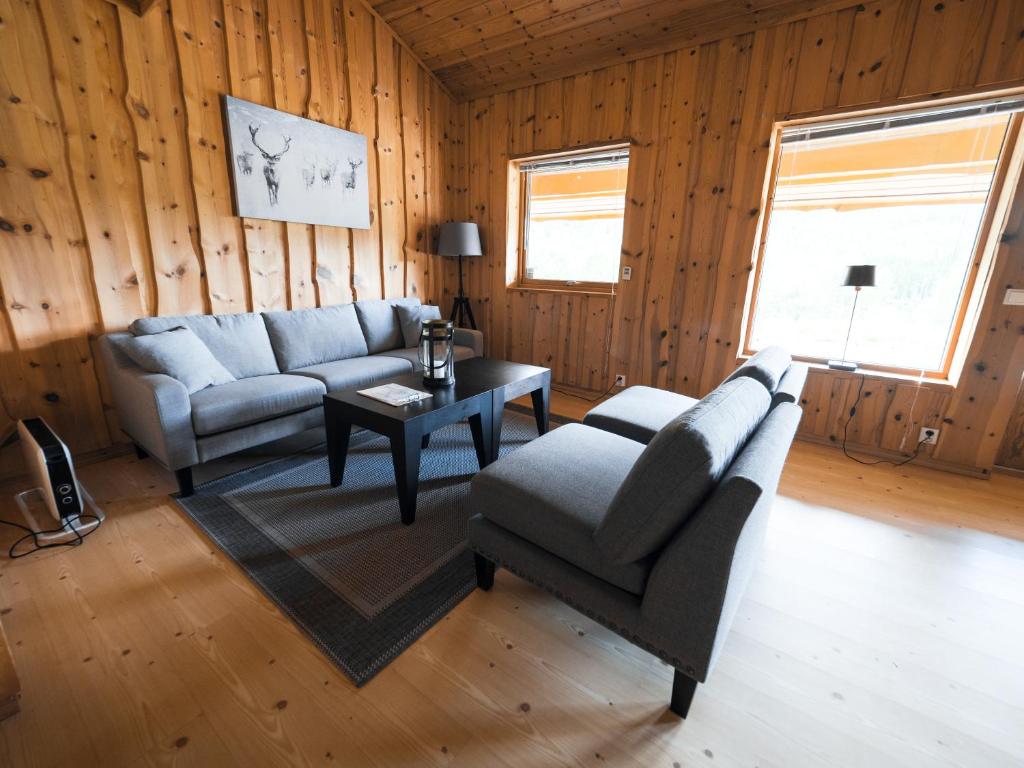 a living room with two couches and a table at Blåtind Apartments in Stordal