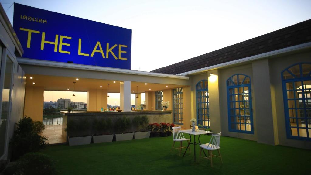 a building with a table and chairs in front of it at The Lake Udon in Udon Thani