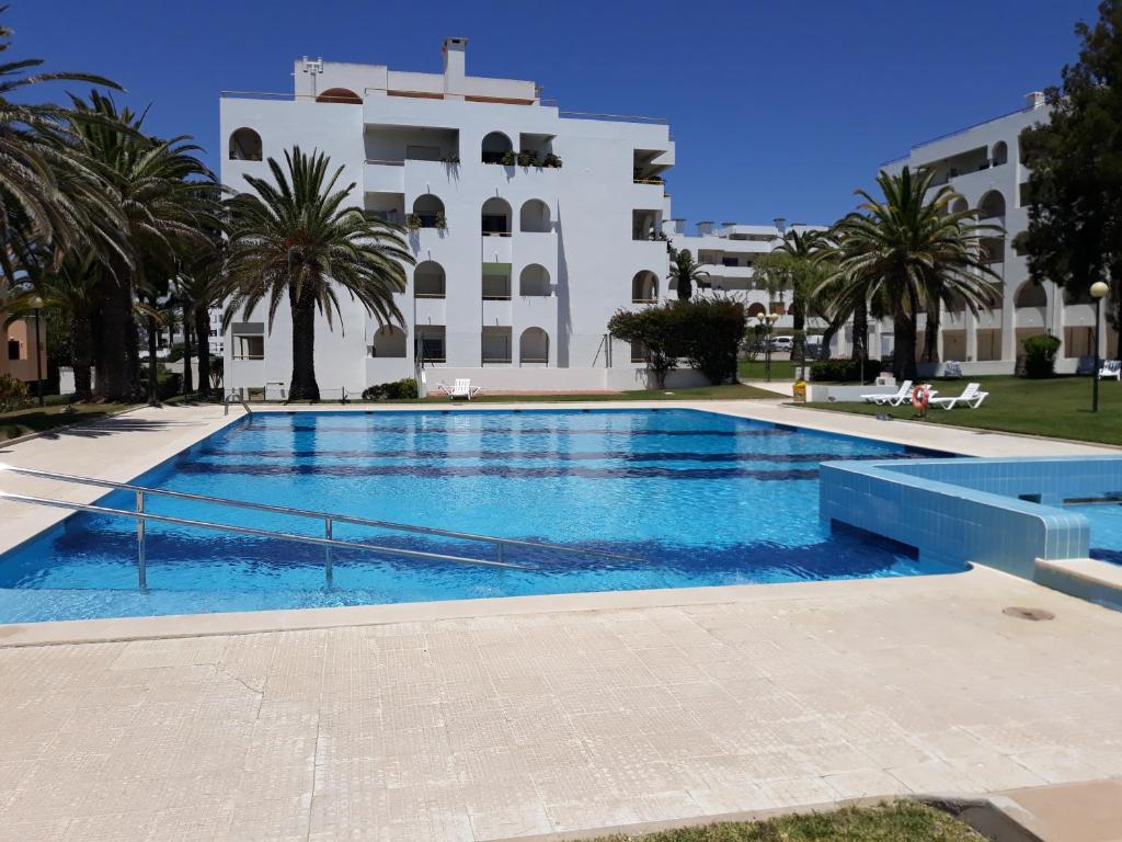 a swimming pool in front of a building at Dreaming of Algarve in Porches