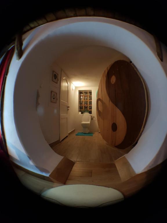 a view of a hallway with a large woodenorthole in a house at Szalupa Hostel Airport in Zakroczym