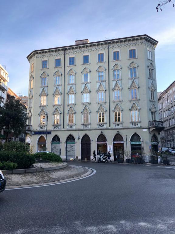 un gran edificio blanco en una calle de una ciudad en CasaNico, en Trieste