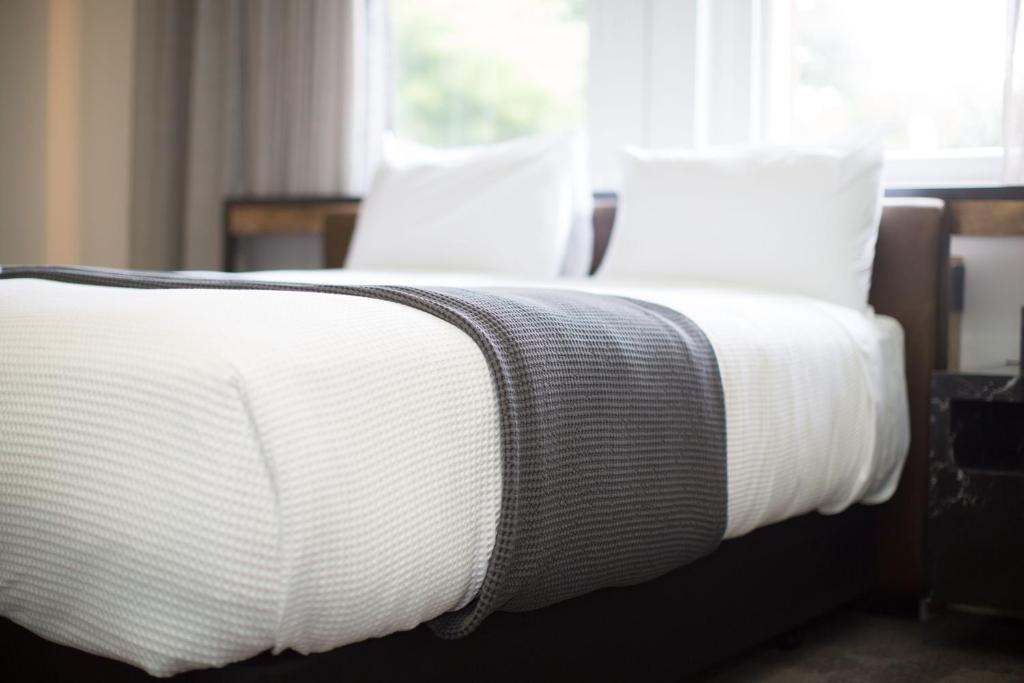 Postel nebo postele na pokoji v ubytování Clarence Boutique Hotel