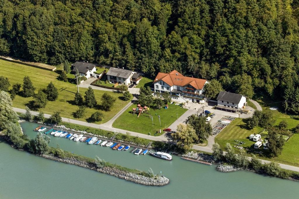 
a large body of water with houses and trees at Gasthof-Pension Luger in Wesenufer
