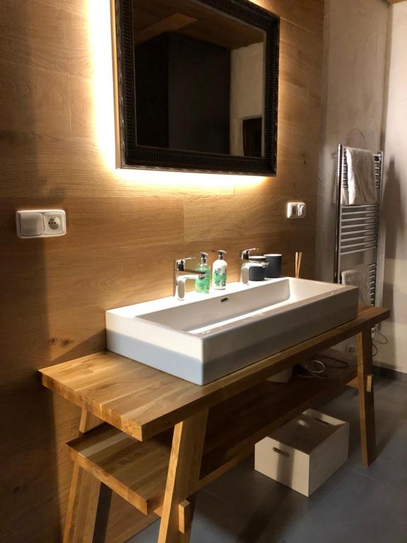 a bathroom with a white sink and a mirror at One-Of-A-Kind NASSFELD APARTMENTS in Sonnenalpe Nassfeld