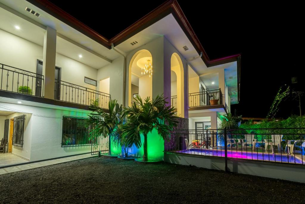 a house with a green and purple lights on it at Apartamentos La Casona in Fortuna