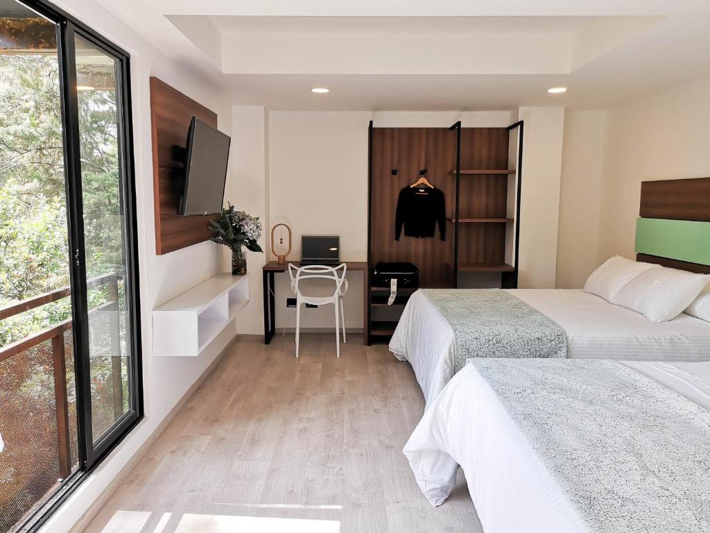 Postel nebo postele na pokoji v ubytování Foresta Hotel