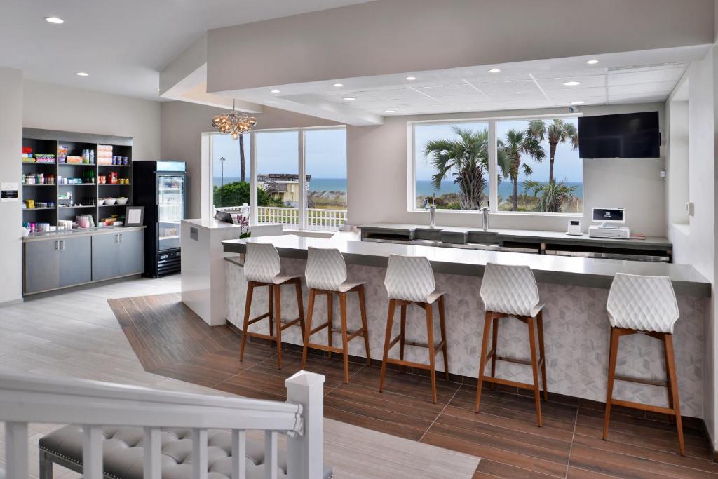 a kitchen with a island with bar stools at Cabana Shores Hotel in Myrtle Beach