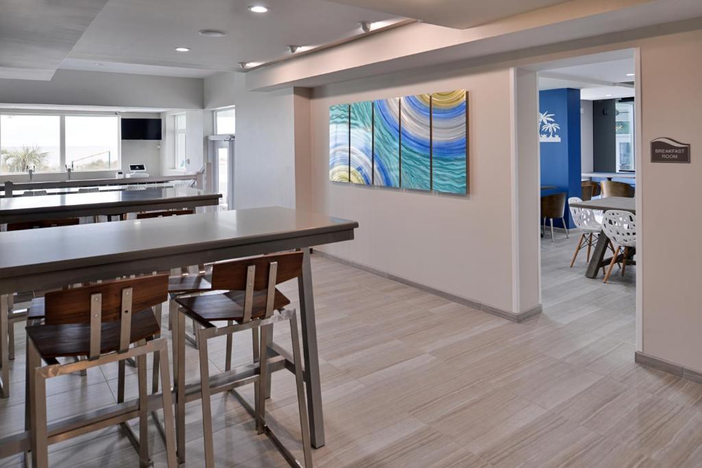 a kitchen and dining room with a counter and chairs at Cabana Shores Hotel in Myrtle Beach
