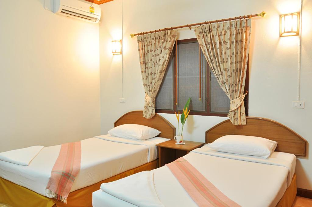 Postel nebo postele na pokoji v ubytování Mira Mare Resort Koh Samui