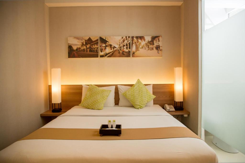 a bedroom with a bed with a suitcase on it at Chic Quarter in Jakarta