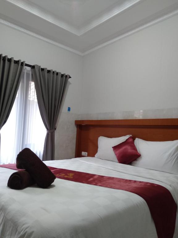 Postel nebo postele na pokoji v ubytování Jepun Segara Guest House