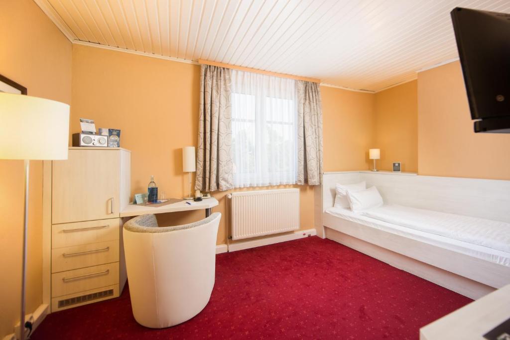 Postel nebo postele na pokoji v ubytování Hotel Am Alten Strom