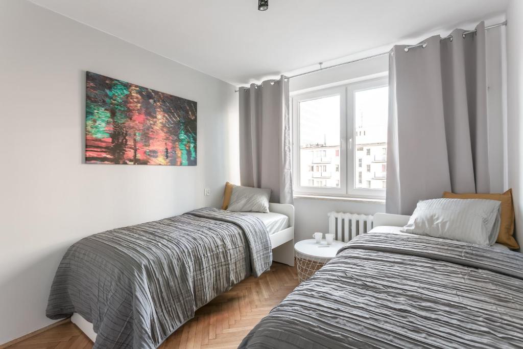 Posteľ alebo postele v izbe v ubytovaní Chill Apartments Pańska