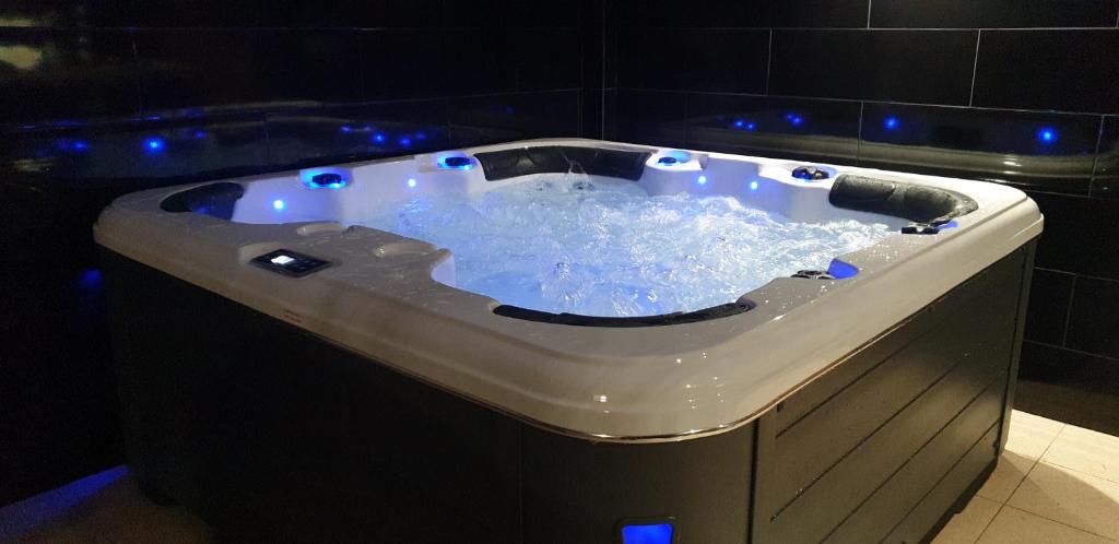a jacuzzi tub in a bathroom with blue lights at Villa Summertime - Private Jacuzzi and bikes, beach 800m in Albufeira