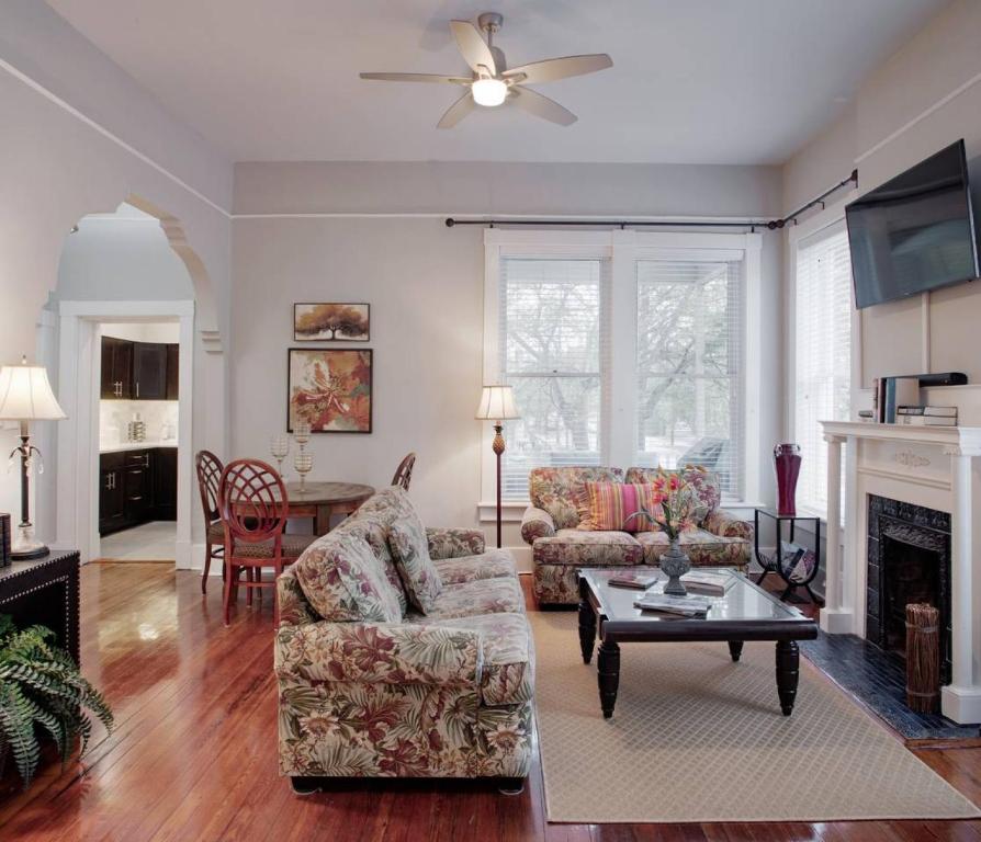 a living room with a couch and a table at 420Waldburg A · Modern Apt with Southern Charm Blocks from Forsyth in Savannah