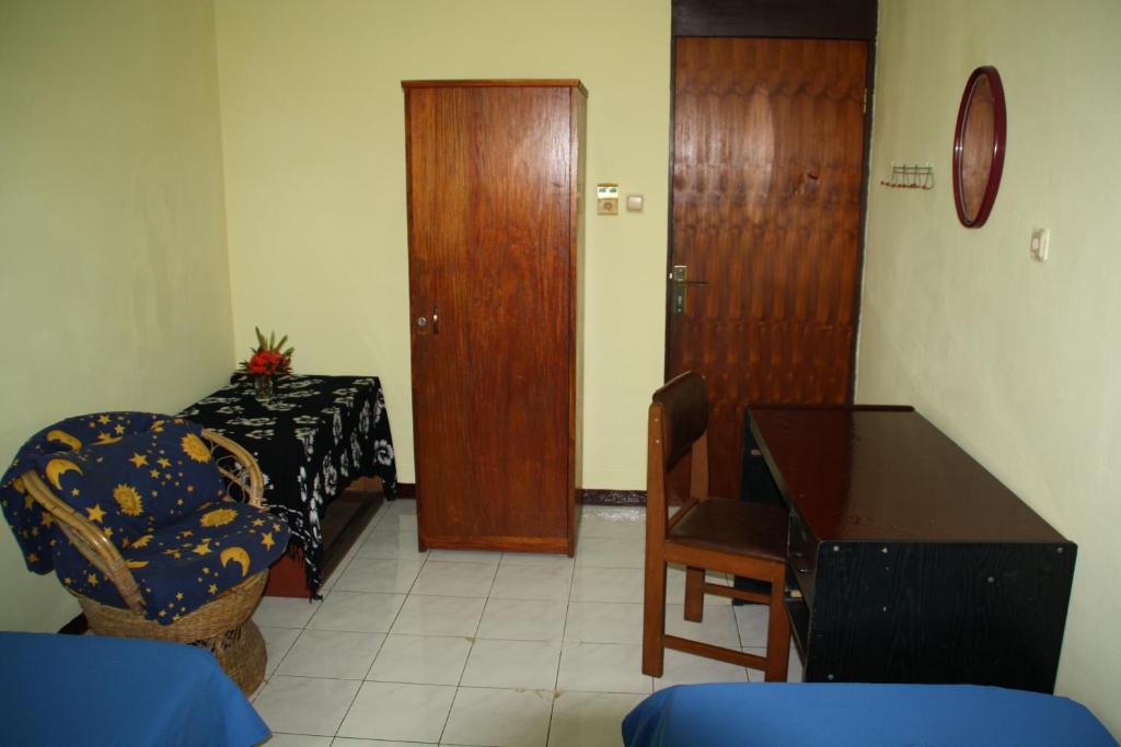 a room with a table and a chair and a desk at Homestay Galpera Papua in Jayapura