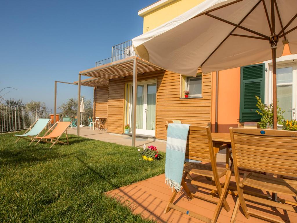 eine Terrasse mit einem Tisch und einem Sonnenschirm in der Unterkunft Creuza de Legnà in Levanto