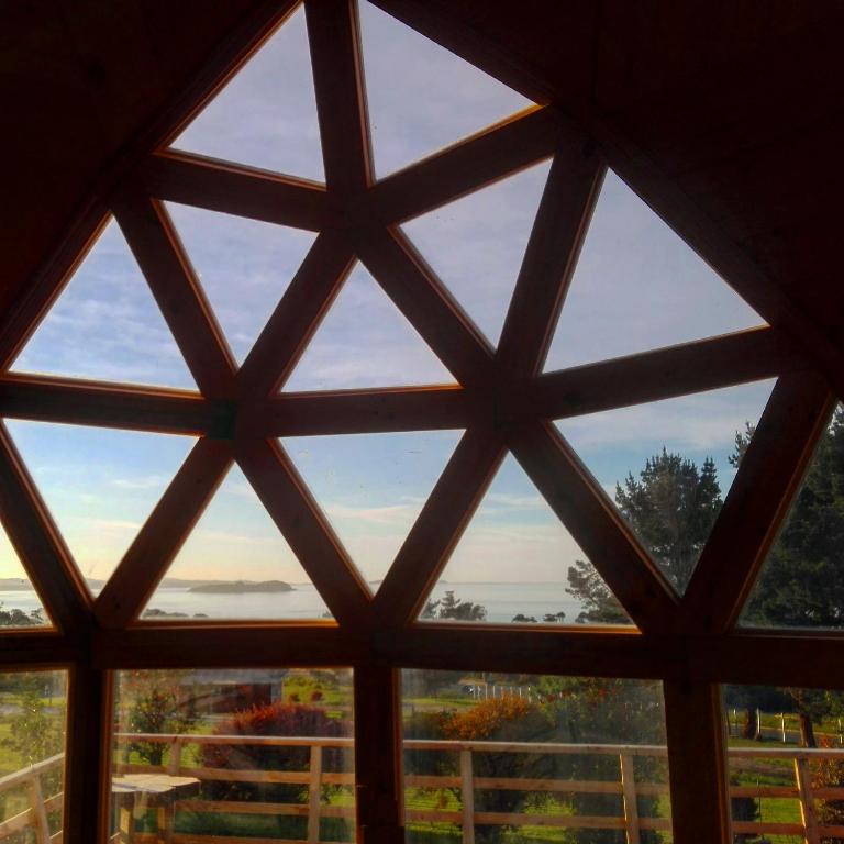 a window view from the inside of a house at domoschiloe in Ancud