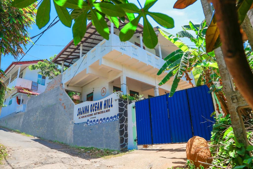 a building with a blue gate at Sajana Ocean Hill in Mirissa