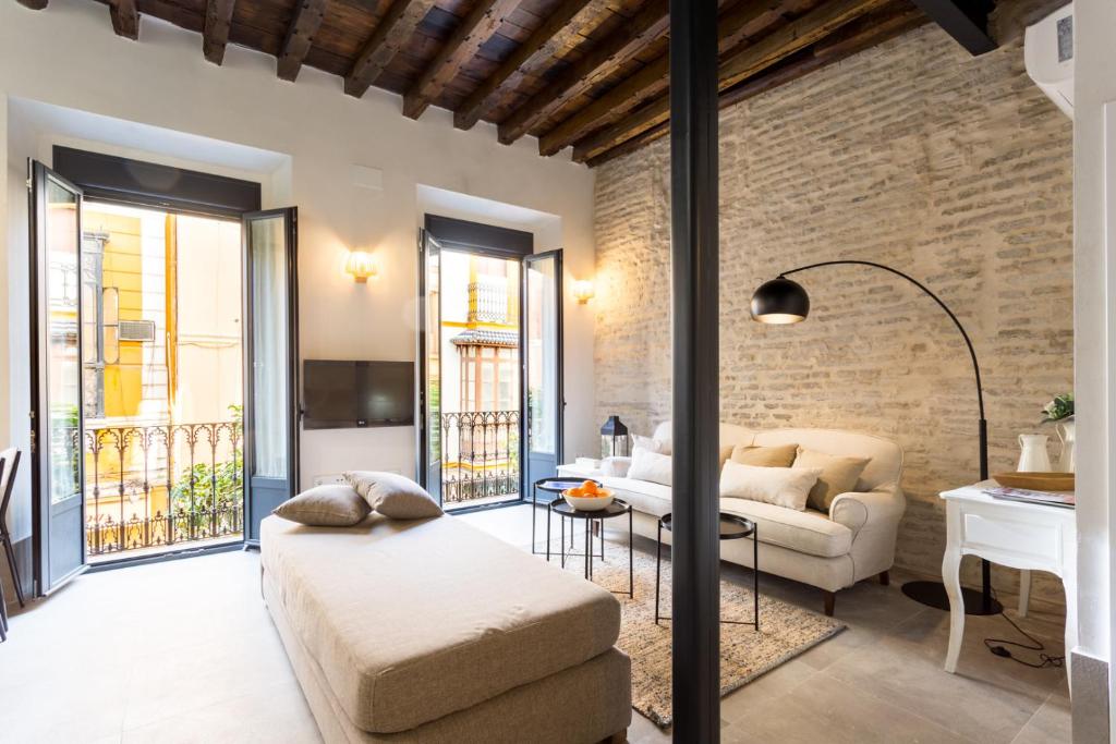 a living room with a couch and a table at Oak & Sandstone Studio - Space Maison Apartments in Seville