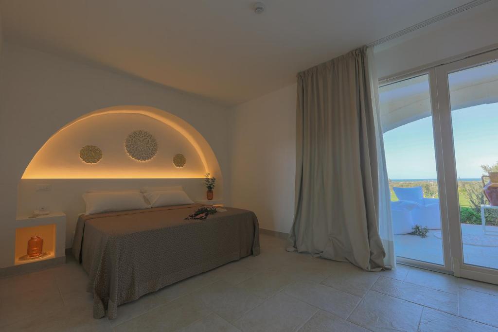 Кровать или кровати в номере Relais Masseria Caselli