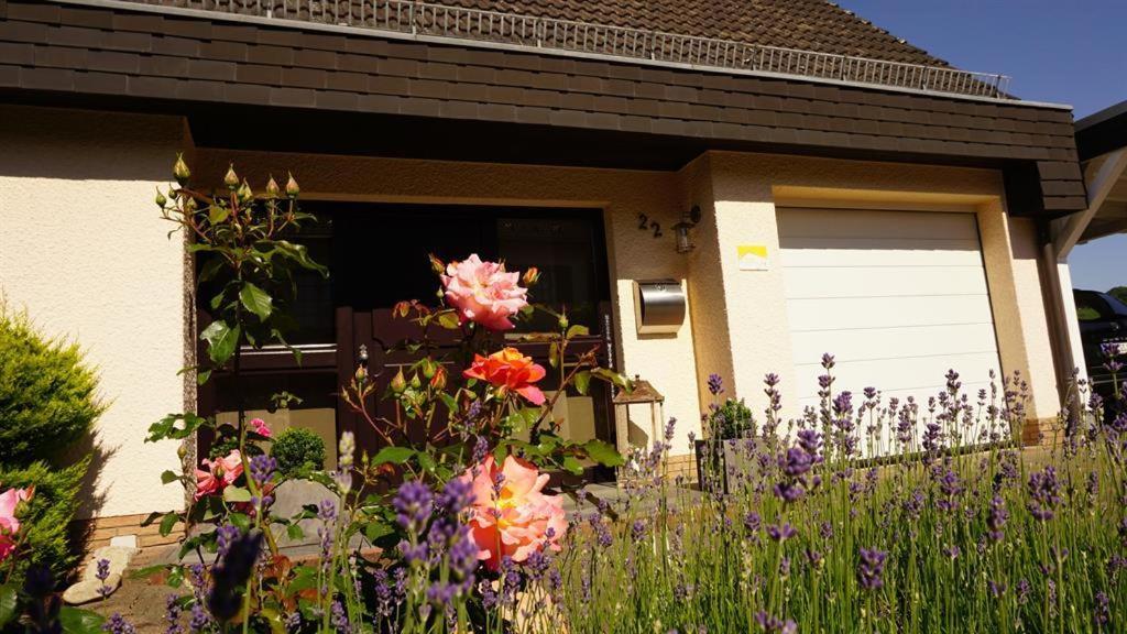 a house with a bunch of flowers in front of it at Ferienwohnung Zum Harpelstein in Horath