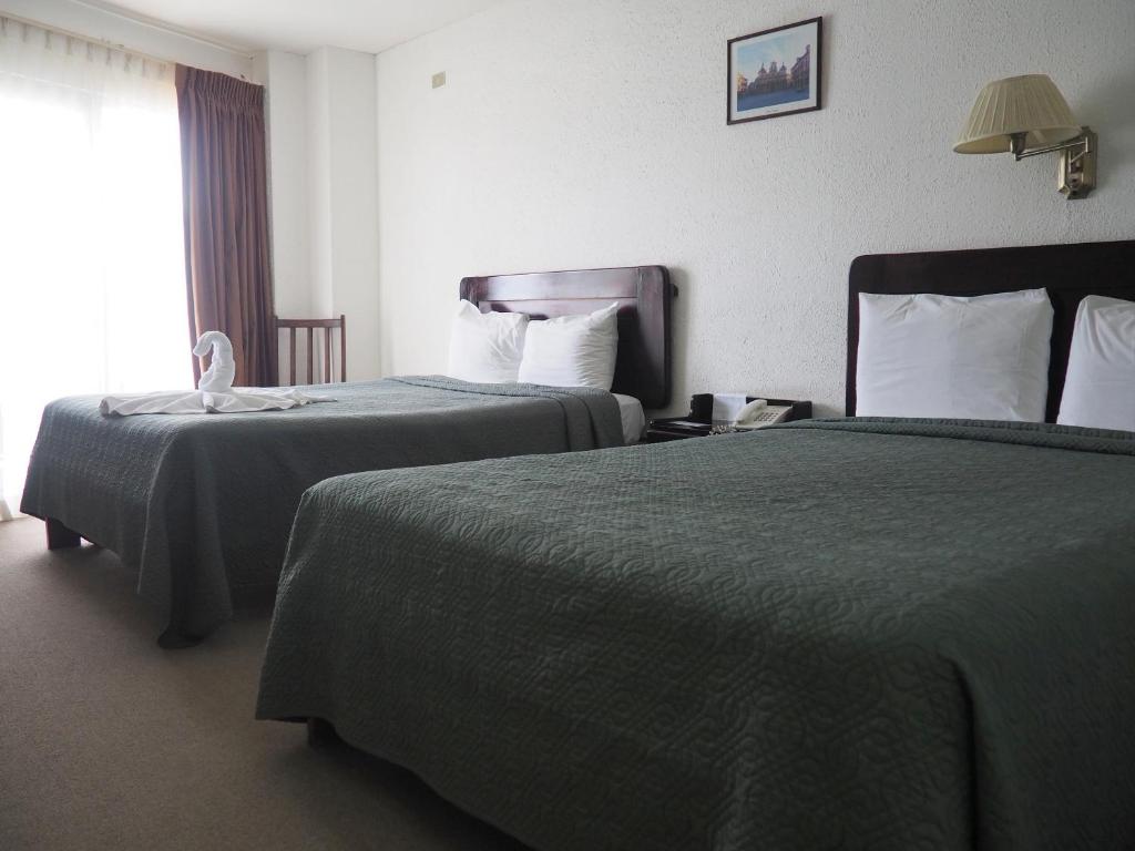 Postel nebo postele na pokoji v ubytování Nuevo Maragato Hotel & Hostel