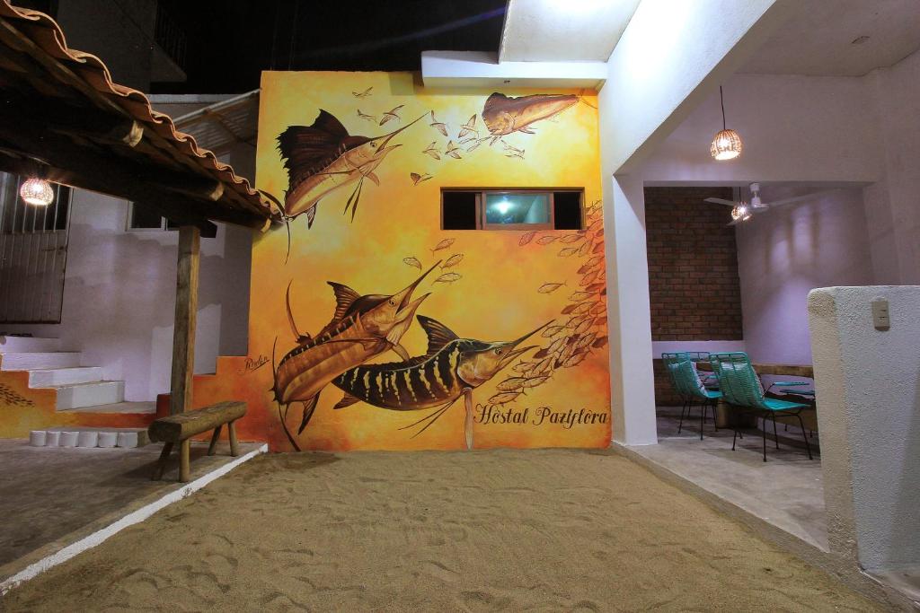 a wall with a painting of a honey bee at Paziflora Hostel in Puerto Escondido