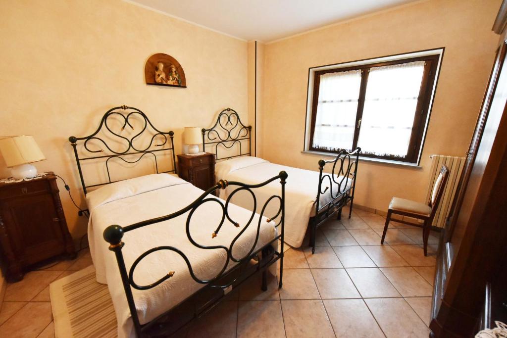 Postel nebo postele na pokoji v ubytování Agriturismo La Ca 'd Majin