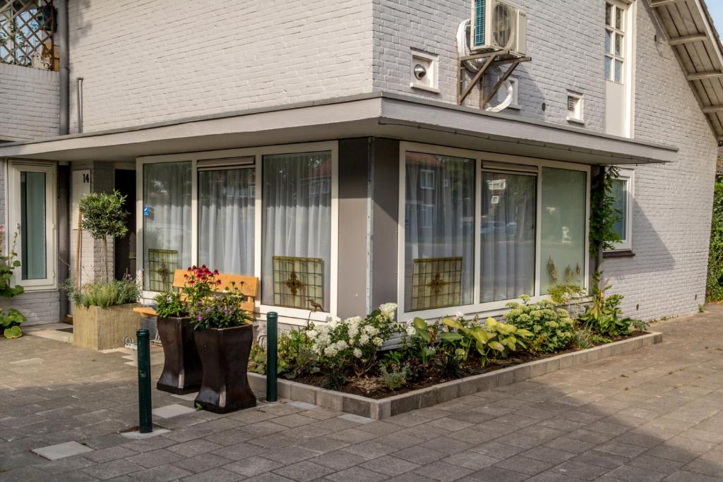 a building with some plants in front of it at B&B Amsterdam De Springer in Amsterdam