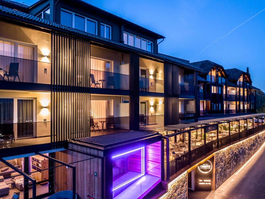 an exterior view of a building with purple lights at Hotel Christof in Appiano sulla Strada del Vino