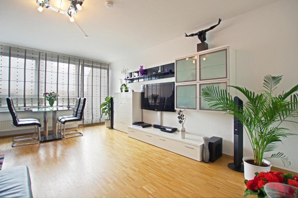 a large living room with a table and chairs at Private Apartments near Exhibition Center in Hannover