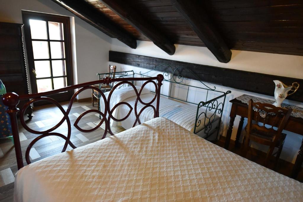 Postel nebo postele na pokoji v ubytování Agriturismo La Ca 'd Majin