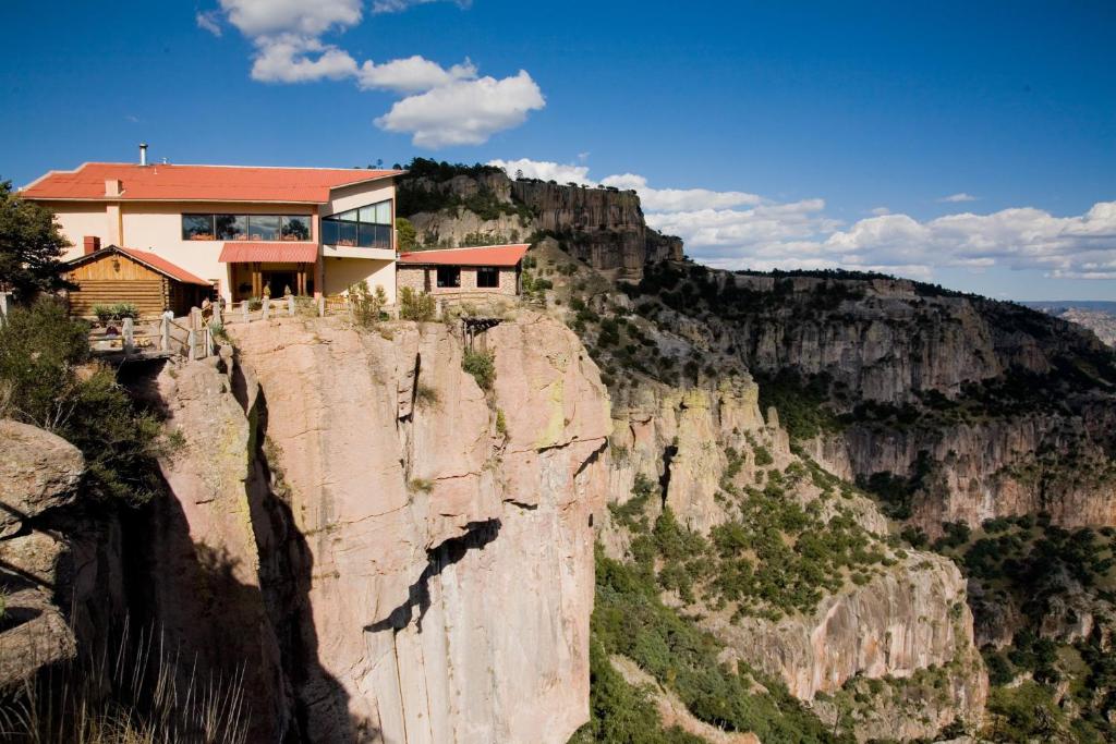 a house perched on the edge of a cliff at Hotel Divisadero Barrancas in El Divisadero