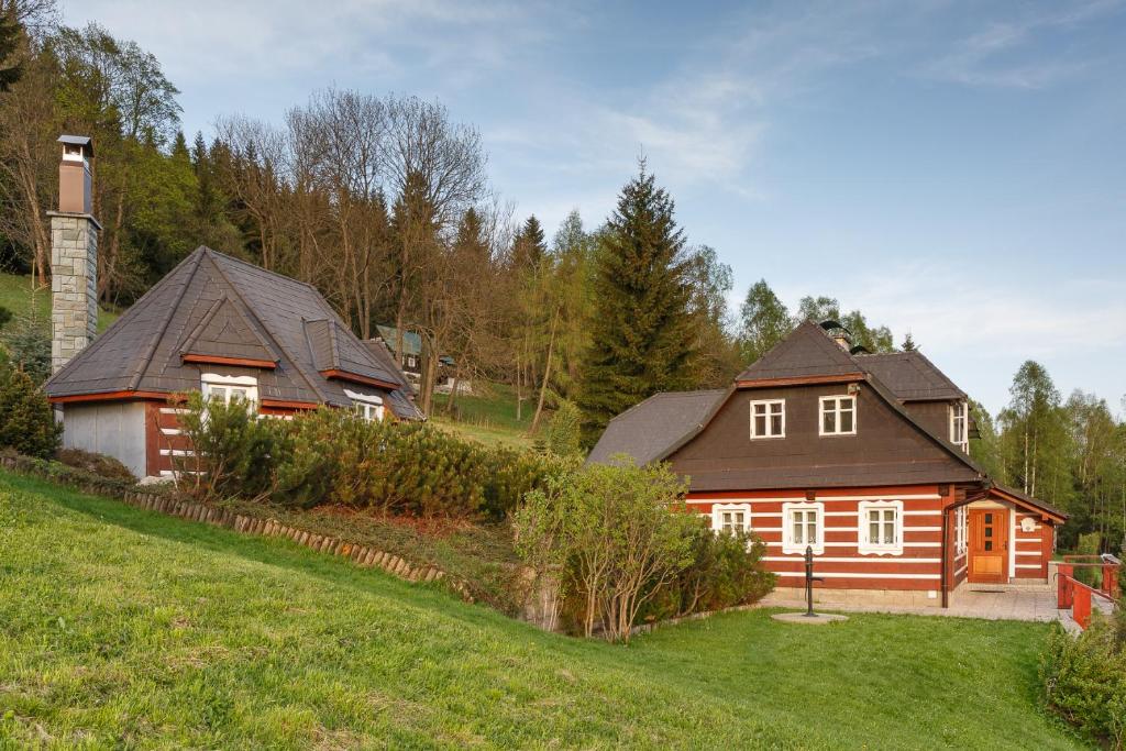 a house in a field next to a yard at Roubenka Anna in Dolní Polubný