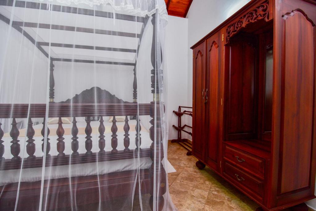 Voodi või voodid majutusasutuse Simon's Lodge Hikkaduwa toas