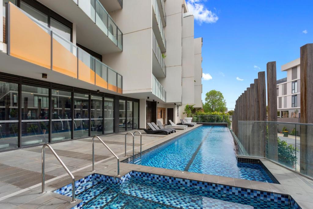 a swimming pool in the middle of a building at Sandy Hill Apartments by Ready Set Host in Sandringham