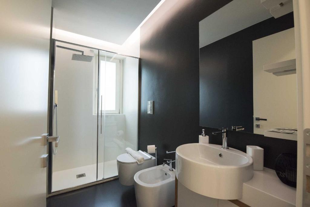 a bathroom with a white sink and a shower at apARTments Sperlonga in Sperlonga