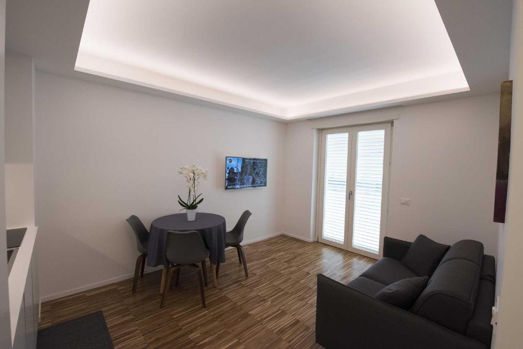 a living room with a couch and a table at apARTments Sperlonga in Sperlonga