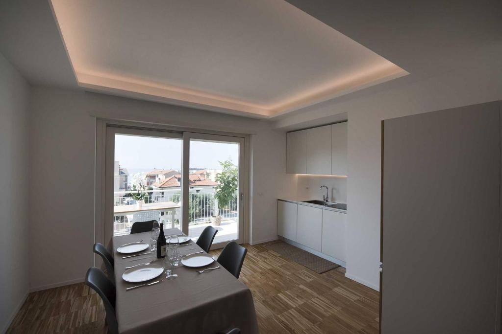 a dining room with a table and a large window at apARTments Sperlonga in Sperlonga