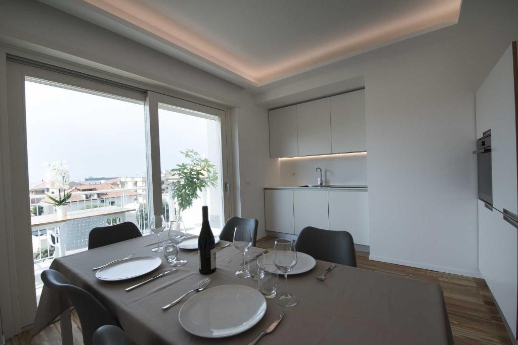 a dining room with a table with wine glasses at apARTments Sperlonga in Sperlonga
