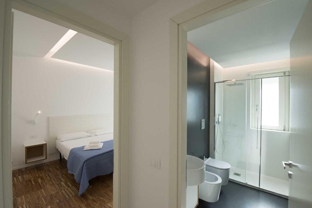 a bedroom with a bed and a bathroom with a mirror at apARTments Sperlonga in Sperlonga