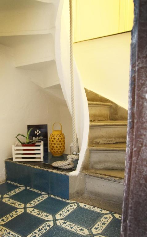 a hallway with stairs with blue and white tiles at Albergo Barbara in Vernazza