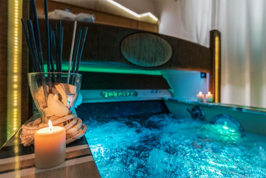 a candle sitting on a table next to a swimming pool at Hotel Butterfly in Torre del Lago Puccini