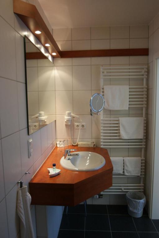 a bathroom with a sink and a mirror at Bertricher Hof in Bad Bertrich