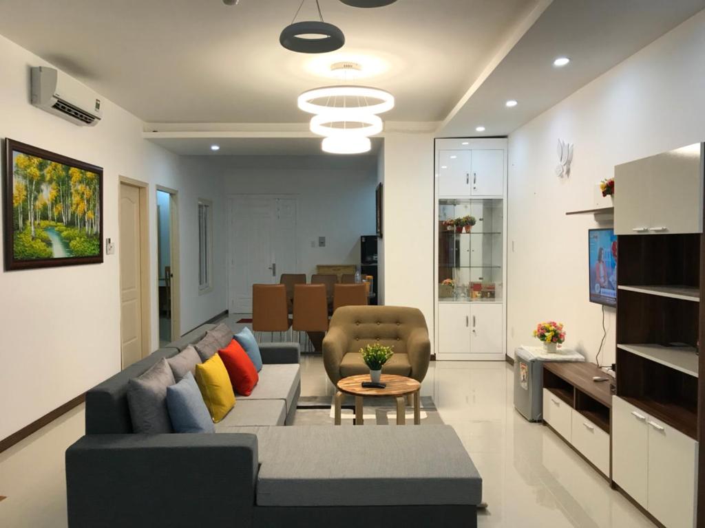 a living room with a couch and a table at The Grand Condotel in Vung Tau