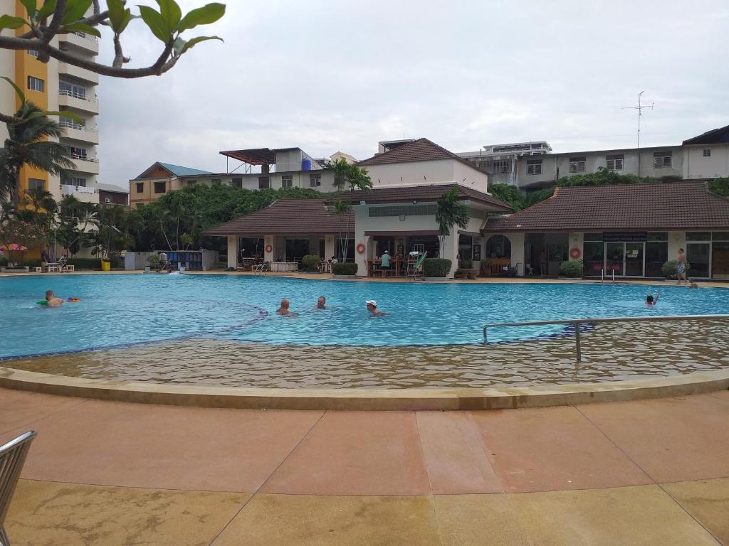a group of people swimming in a swimming pool at B&B view talay 1 jomtien pattaya in Pattaya South