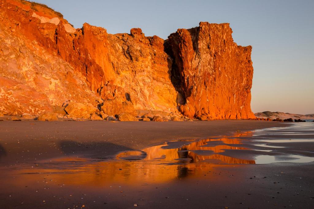 a view of a beach with a cliff at Serra da Redonda in Redonda