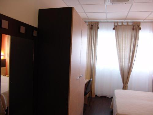 Postel nebo postele na pokoji v ubytování Hotel Milano