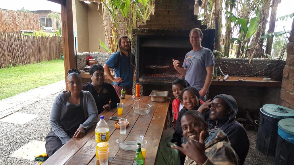 a group of people sitting around a table at The Wild Farm Backpackers in Wilderness